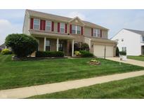 Charming two-story home featuring a well-maintained lawn and attached two-car garage at 8358 Balmoral Dr, Avon, IN 46123