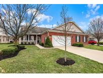 Charming brick home with a well-manicured lawn and a two car garage, perfect for suburban living at 10629 Medinah Dr # 1, Indianapolis, IN 46234