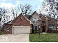 Charming two-story home with a brick facade, attached two car garage, and well-maintained landscaping at 12441 Bent Oak Ln, Indianapolis, IN 46236