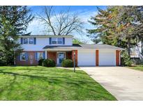 Charming two-story home with brick accents, a well-maintained lawn, and an attached two-car garage at 1840 Park Valley Dr, Columbus, IN 47203