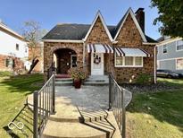 Charming brick home with landscaped front yard, walkway and peaked roofline at 303 S Walnut St, Edinburgh, IN 46124