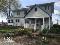 Charming home with a well-maintained lawn, lovely flowerbeds, and a welcoming front porch at 3030 N 600 E, Lebanon, IN 46052