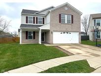 Charming two-story home featuring a well-maintained lawn, a two-car garage, and a welcoming front porch at 373 Springfield Cir, Greenwood, IN 46143