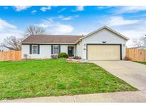 Charming single-story home featuring a well-maintained lawn and an attached two-car garage at 6036 Terrytown Pkwy, Indianapolis, IN 46254