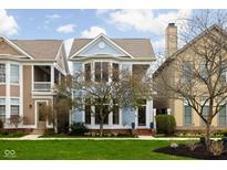 Charming two-story home with light blue siding, bay windows, and well-manicured front lawn at 634 N Senate Ave, Indianapolis, IN 46202