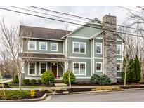 Beautiful two-story home with a stone chimney and inviting front porch at 768 Trailside Dr, Carmel, IN 46032