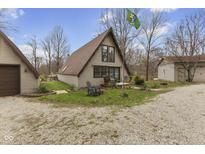 Charming A-frame home with a neatly manicured front lawn and a gravel driveway at 7968 Center Lake Rd, Nineveh, IN 46164