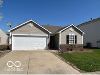 Charming ranch-style home with a two-car garage and well-maintained lawn at 11876 Wapiti Way, Noblesville, IN 46060