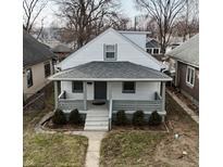Charming home featuring a cozy front porch and well-maintained landscaping at 1216 N Holmes Ave, Indianapolis, IN 46222