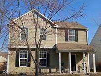 Charming two-story home features a well-maintained lawn and inviting front porch, nestled under a clear blue sky at 13124 S Elster Way, Fishers, IN 46037