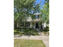Charming two-story home featuring a covered front porch and well-maintained landscaping at 13124 S Elster Way, Fishers, IN 46037