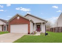 Charming single-Gathering home with red brick accents, attached garage, and well-maintained lawn at 15433 Wandering Way, Noblesville, IN 46060