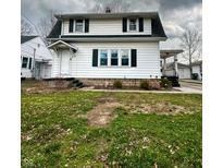 Charming two-story home with a classic design and inviting front porch at 1627 E 8Th St, Anderson, IN 46012
