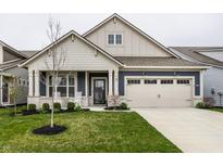 Charming home featuring a well-manicured lawn, a covered front porch, and a neutral color palette at 19668 Mcdonald Pl, Westfield, IN 46074