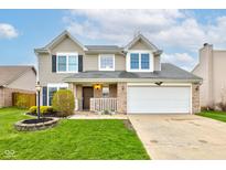 Traditional two-story home featuring a two-car garage, manicured lawn and inviting landscaping at 20107 Marie Ct, Noblesville, IN 46062