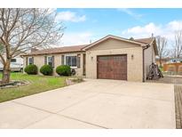 Charming brick home featuring a large driveway, an attached garage, and well-maintained landscaping at 301 Lancelot Dr, Franklin, IN 46131