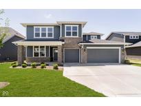 Beautiful two-story home featuring a lawn, grey siding, stone accents and an attached two car garage at 3241 Fawn Cir, Brownsburg, IN 46112