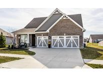 Charming home with a two-car garage, brick facade, grey siding, and a well-manicured front lawn at 3849 Sun Valley Dr, Westfield, IN 46074