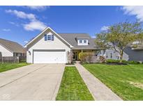 Charming home with a two-car garage, landscaped front yard, and inviting front porch at 3856 Cornwallis Ln, Carmel, IN 46032