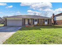 Charming single-story brick home with an attached garage and a well-maintained front lawn at 4744 Whirlaway Dr, Indianapolis, IN 46237