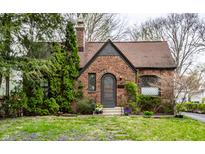 Charming brick home with landscaped front yard, stone pathway, and arched front door at 5683 Guilford Ave, Indianapolis, IN 46220