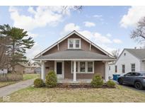 Charming bungalow with a well-maintained front yard and classic architectural details at 6158 Ralston Ave, Indianapolis, IN 46220