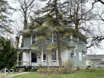Charming two-story home with a covered front porch and mature trees in a residential neighborhood at 1325 S Hackley St, Muncie, IN 47302