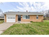Charming brick ranch home featuring an attached garage and a well-manicured front lawn at 1700 N Tibbs Ave, Indianapolis, IN 46222
