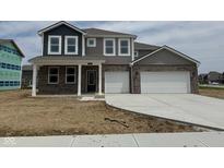 Two-story home with a two-car garage, stone facade, and covered front porch at 240 Ames Dr, Whiteland, IN 46184