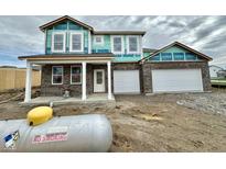 New two-story brick home featuring an attached two-car garage and covered front porch at 240 Ames Dr, Whiteland, IN 46184