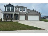 Two-story home boasts a two-car garage, gray brick accents, covered porch, and manicured front yard at 240 Ames Dr, Whiteland, IN 46184