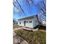 Charming one-story home with light green siding, white trim, and a cozy front porch and walkway at 2627 Chase St, Anderson, IN 46016