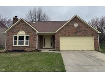 Charming brick home with attached garage and well-maintained lawn at 3734 Ontario Cir, Indianapolis, IN 46268