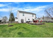 A well maintained lawn surrounds a paver patio with comfortable seating and room for backyard activities at 4345 Elkhorn Dr, Westfield, IN 46062