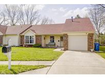 Charming one-story home featuring a well-manicured lawn, brick accents, and an attached garage at 5417 Kerns Ln, Indianapolis, IN 46268