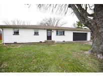 Charming single-story home featuring a painted brick facade and attached one-car garage at 5557 W Us Highway 52, New Palestine, IN 46163