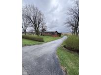 Charming brick ranch home featuring a long driveway and mature trees on a spacious lot at 6835 W Us Highway 36, Danville, IN 46122