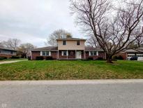Charming two-story home featuring a classic brick facade and manicured lawn on a tree-lined street at 951 Apple Valley Rd, Greenwood, IN 46142