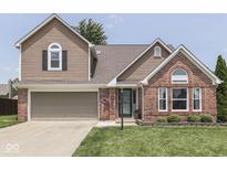 Charming two-story home with a well-manicured lawn and beautiful brick and siding accents at 1228 Easton Point Dr, Greenwood, IN 46142