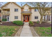 Attractive condo complex with landscaped entrance and bright, red door at 12570 Timber Creek Dr # 7, Carmel, IN 46032