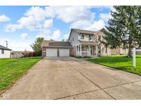 Charming brick and siding two-story home with a two-car garage and a spacious front yard at 1598 Thornburg Ln, Franklin, IN 46131