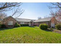 Charming brick home featuring a lush green lawn and mature landscaping under a clear blue sky at 1791 S Conservation Club Rd, Morgantown, IN 46160