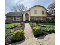 Charming exterior with brick walkway and lovely landscaping in the front yard at 1813 Birch Dr, Plainfield, IN 46168