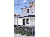 Charming two-story home with white siding, black trim, and a covered front porch at 241 N Tacoma Ave, Indianapolis, IN 46201