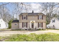 Charming two-story home with a stone facade, classic shutters, and a well-manicured lawn at 25 W 59Th St, Indianapolis, IN 46208