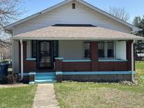 Charming single-Gathering home featuring a covered porch with brick columns and freshly painted trim at 359 N Whitcomb Ave, Indianapolis, IN 46224