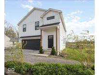 Charming two-story modern farmhouse exterior with a black garage door and landscaping at 431 W Main St, Lizton, IN 46149