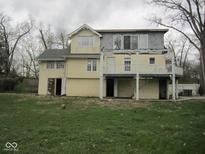 A two-story home with a deck on the back and a lawn at 5657 E Fall Creek Pkwy N Dr, Indianapolis, IN 46226