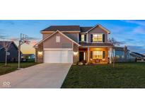 Charming two-story home featuring a basketball hoop, brick accents, and a well-maintained front yard at 6476 W Mulberry Way, Greenfield, IN 46140