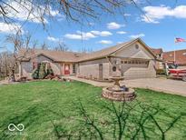 Charming single-story home with a well-maintained lawn, brick exterior, and a welcoming two-car garage at 656 Bakeway Cir, Indianapolis, IN 46231